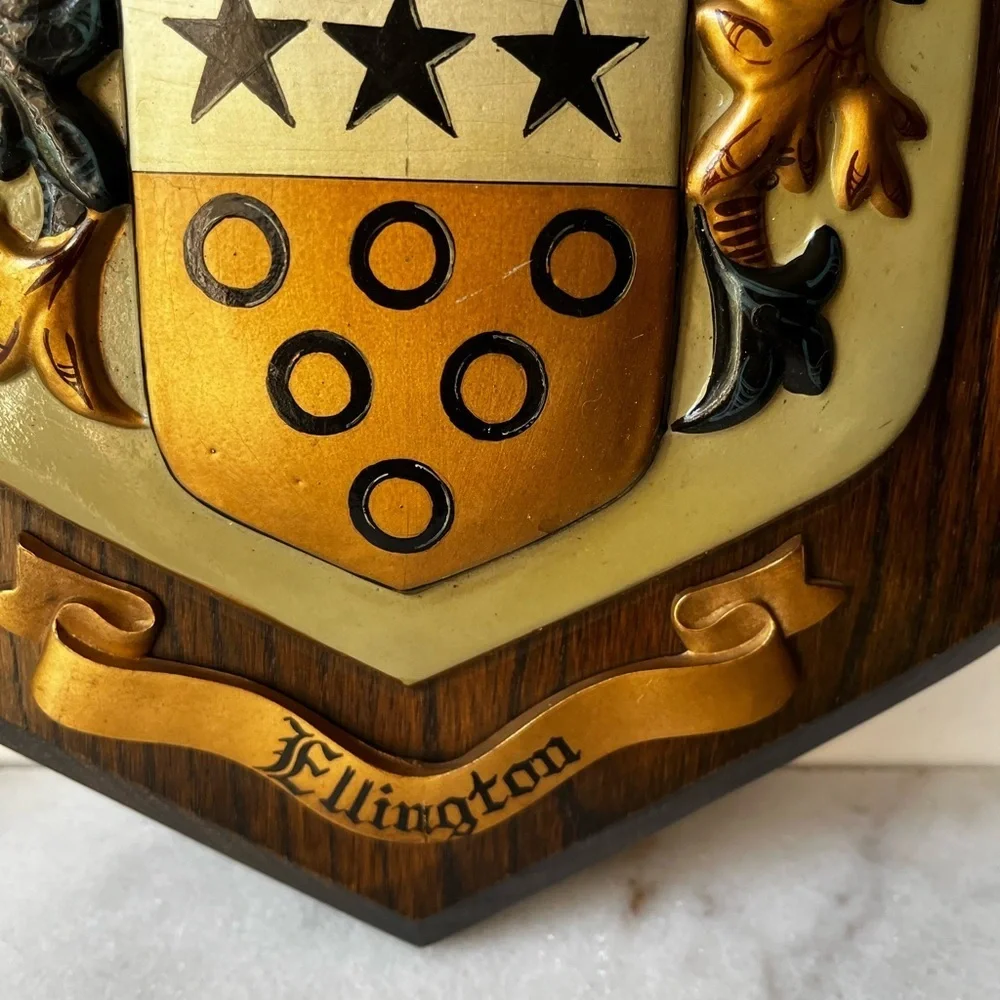wooden plaques featuring family crests or coats of arms. McBrayer and Fllington.